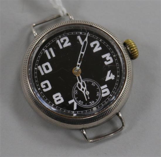 A gentlemans early 20th century silver manual wind wrist watch with black dial and subsidiary seconds, no strap.